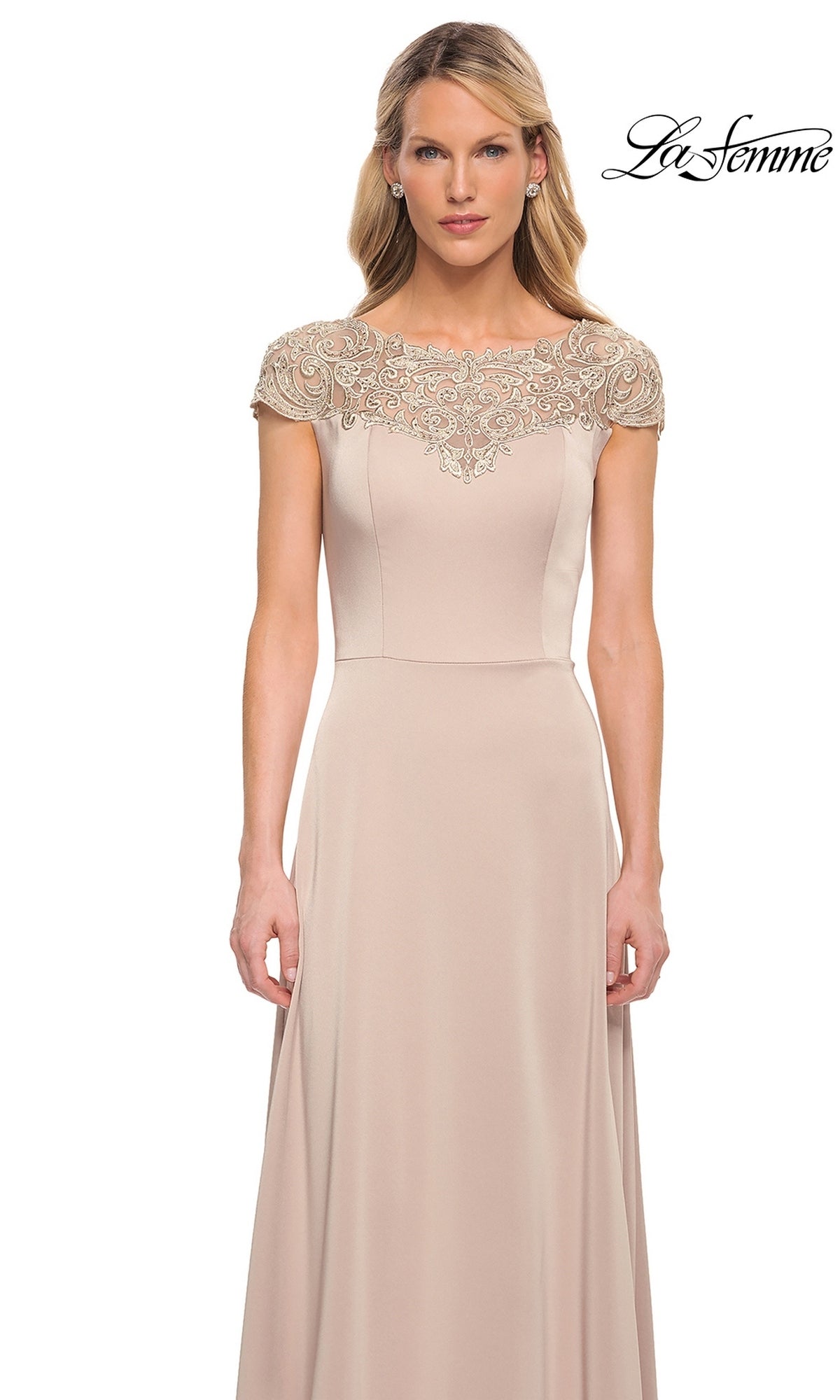 Woman wearing the Long Formal Dress: La Femme 29511, a floor-length light beige gown with an A-line skirt, embroidered cap sleeves, and a detailed neckline.